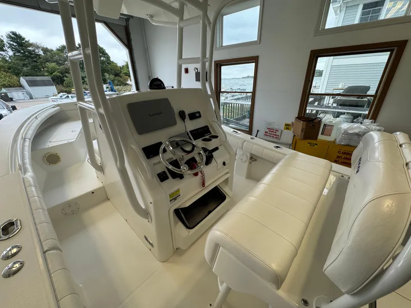 Slide: The Image of 2012 Regulator 24 Forward Seating boat interior with helm and seating. - 9