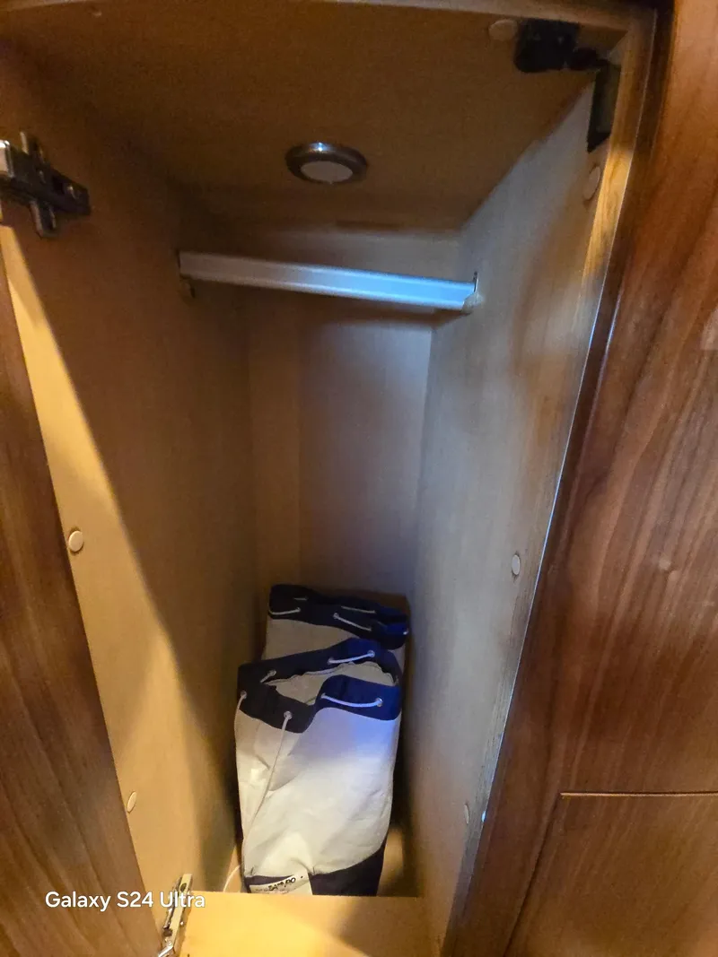 Slide: The Image of Wooden storage compartment inside 2022 Riviera 54 Enclosed Flybridge yacht. - 24