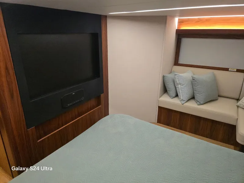 Slide: The Image of Interior of 2022 Riviera 54 Enclosed Flybridge with TV and seating area. - 28