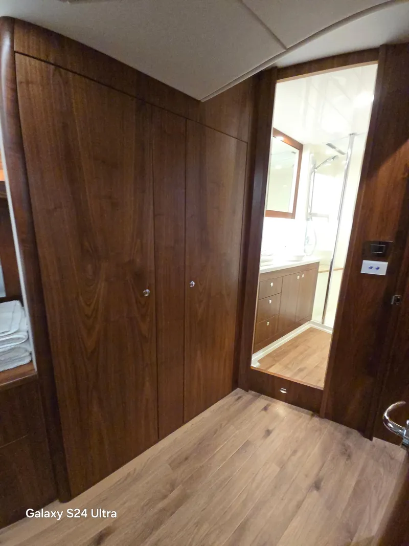Slide: The Image of Interior of 2022 Riviera 54 Enclosed Flybridge with wooden cabinetry and modern bathroom. - 31