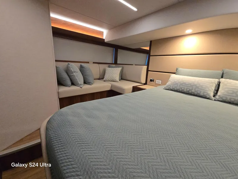 Slide: The Image of Luxurious bedroom interior of 2022 Riviera 54 Enclosed Flybridge yacht with elegant bedding. - 40