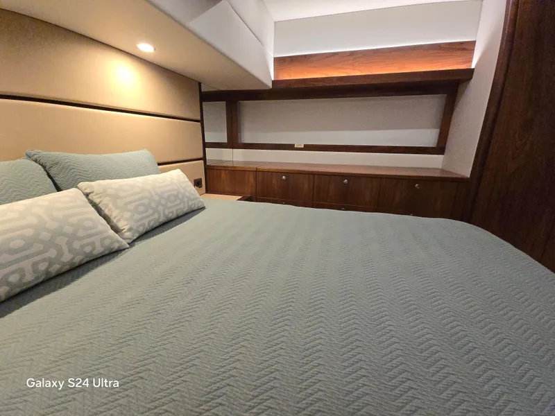 Slide: The Image of Luxurious bedroom interior of 2022 Riviera 54 Enclosed Flybridge yacht. - 42