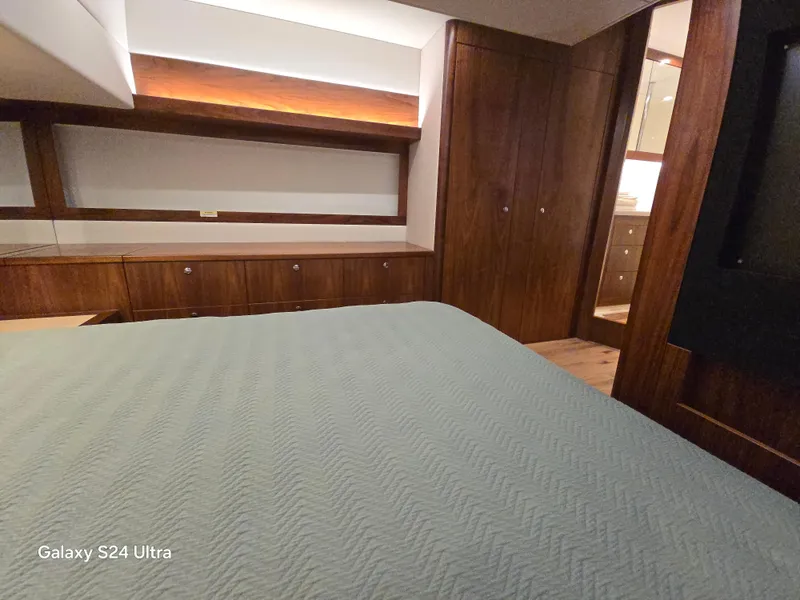 Slide: The Image of Luxurious interior of 2022 Riviera 54 Enclosed Flybridge yacht bedroom. - 43