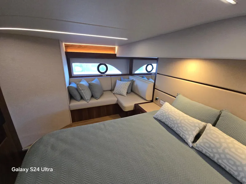 Slide: The Image of Luxurious bedroom interior of 2022 Riviera 54 Enclosed Flybridge yacht with elegant bedding. - 48