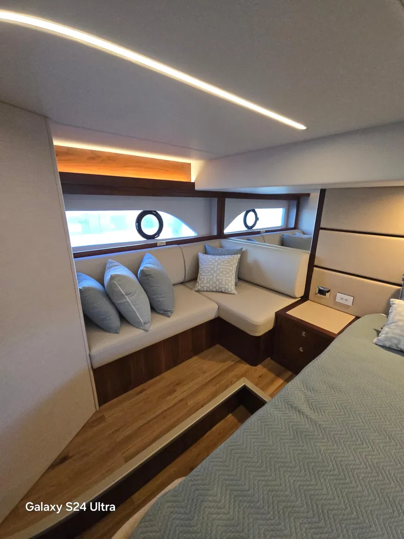 Slide: The Image of Luxurious interior of 2022 Riviera 54 Enclosed Flybridge with elegant seating and modern design. - 49