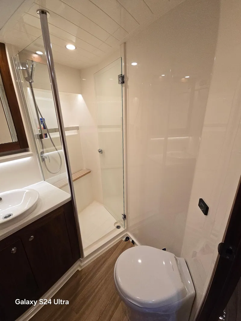 Slide: The Image of Luxurious bathroom in 2022 Riviera 54 Enclosed Flybridge yacht with modern fixtures. - 5