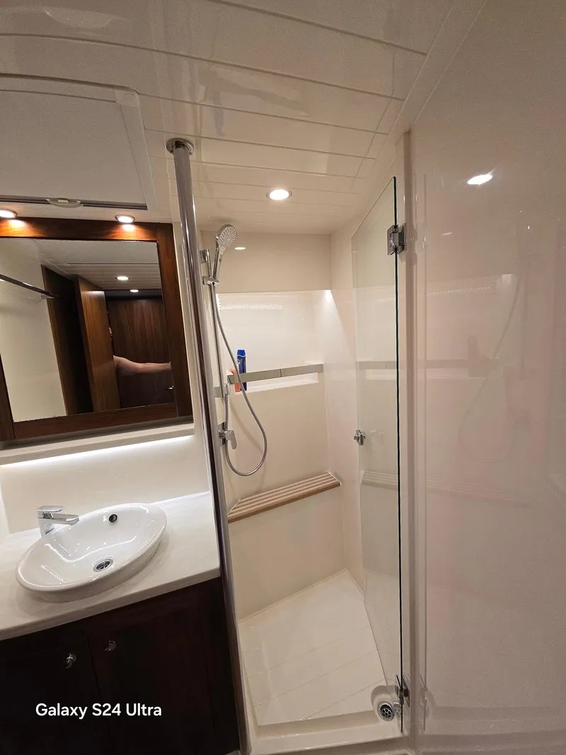 Slide: The Image of Luxurious bathroom in 2022 Riviera 54 Enclosed Flybridge yacht with modern fixtures. - 8