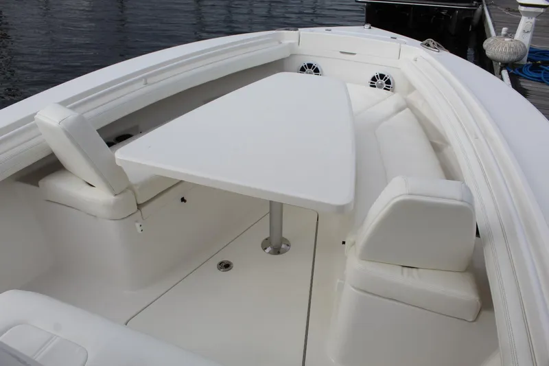 Slide: The Image of 2021 Regulator 23 FS boat interior with white seating and table. - 10