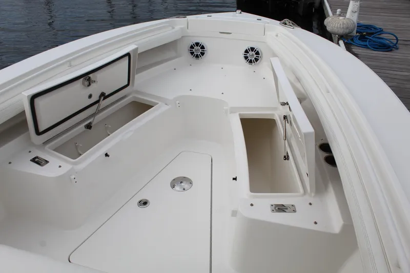 Slide: The Image of 2021 Regulator 23 FS boat interior with open storage compartments and speakers. - 12