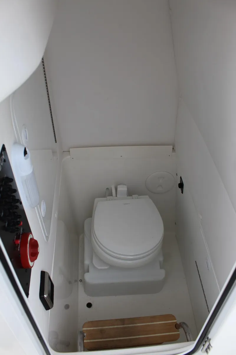 Slide: The Image of 2021 Regulator 23 FS boat interior with compact marine toilet. - 13