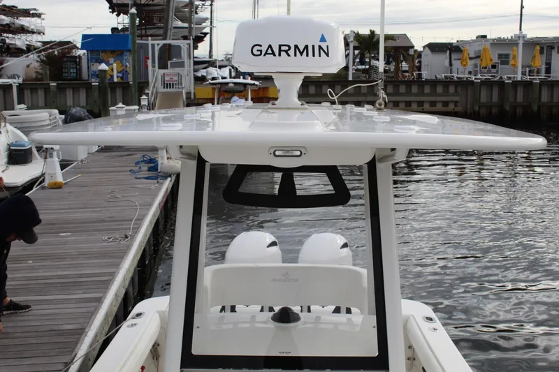 Slide: The Image of 2021 Regulator 23 FS boat with Garmin equipment docked at a marina. - 14