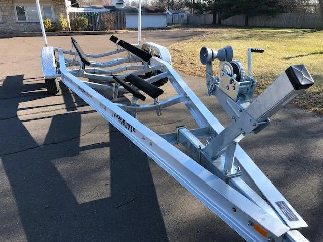 Slide: The Image of Boat trailer for 2021 Regulator 23 FS, parked on pavement in a residential area. - 15