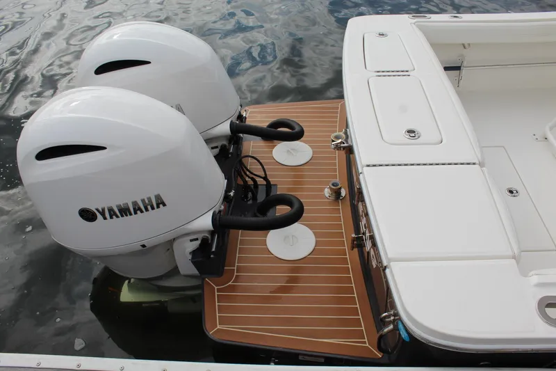 Slide: The Image of 2021 Regulator 23 FS boat with twin Yamaha outboard engines on a wooden platform. - 4