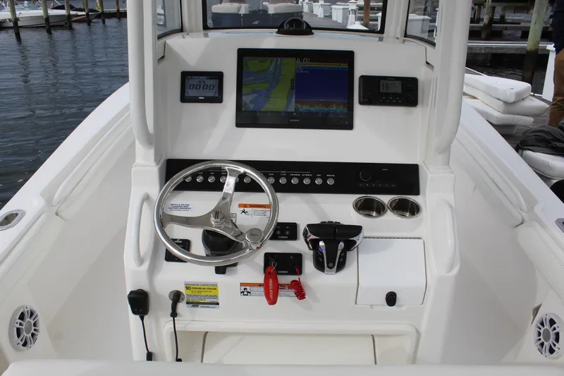 Slide: The Image of 2021 Regulator 23 FS boat console with steering wheel and navigation displays. - 5