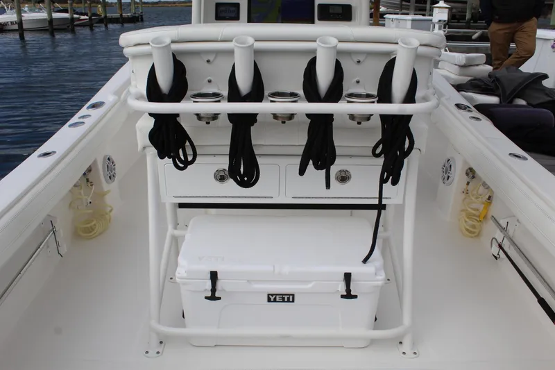 Slide: The Image of 2021 Regulator 23 FS boat interior with rod holders and Yeti cooler. - 6