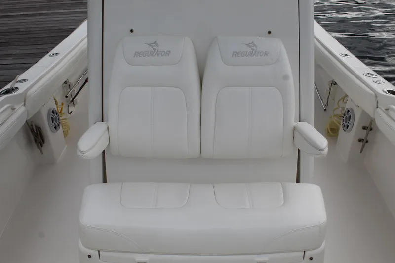 Slide: The Image of 2021 Regulator 23 FS boat with white cushioned seating and armrests. - 8