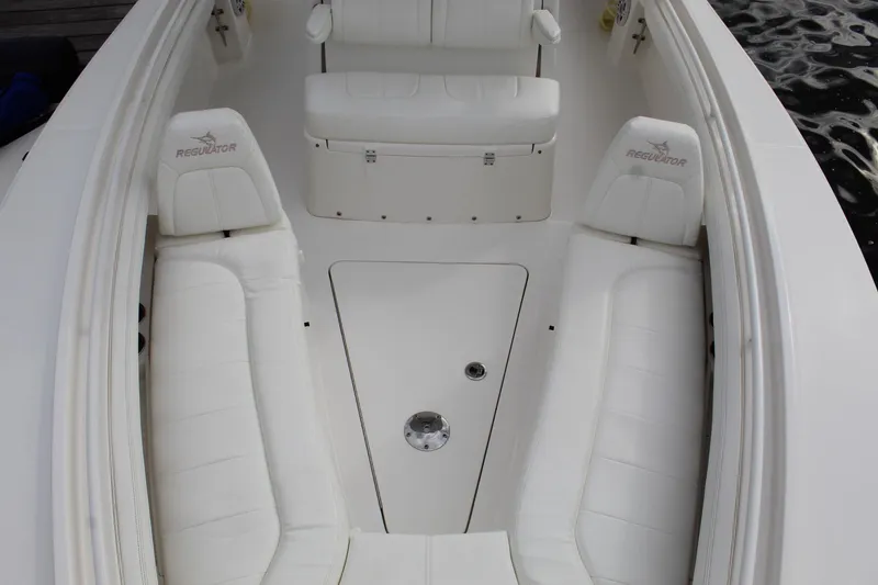Slide: The Image of 2021 Regulator 23 FS boat interior with white seating and storage compartments. - 9