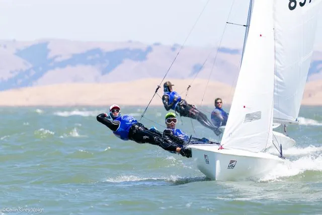 Slide: The Image of Sailors racing on a 2025 One Design ZIM Club 420 sailboat in windy conditions. - 3