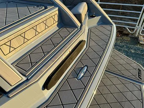 Slide: The Image of 2025 MB B52 25 Alpha boat deck with textured flooring and sleek design. - 12