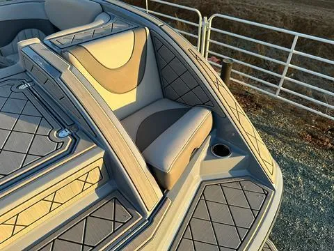 Slide: The Image of Bow seating area of 2025 MB B52 25 Alpha boat with cushioned seats and cup holder. - 13