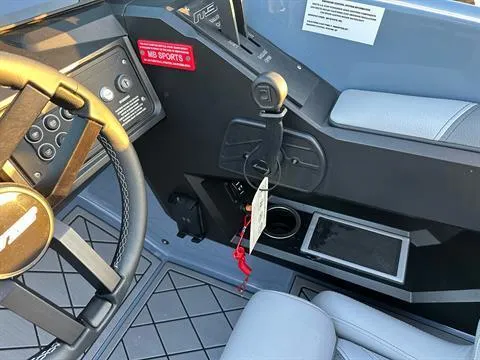 Slide: The Image of Interior of 2025 MB B52 25 Alpha boat, featuring steering wheel and control panel. - 16