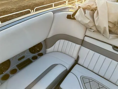 Slide: The Image of 2025 MB B52 25 Alpha boat interior with white and gray seating, sunlight streaming in. - 22