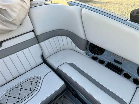 Slide: The Image of 2025 MB B52 25 Alpha boat interior with white and gray seating and cup holders. - 24