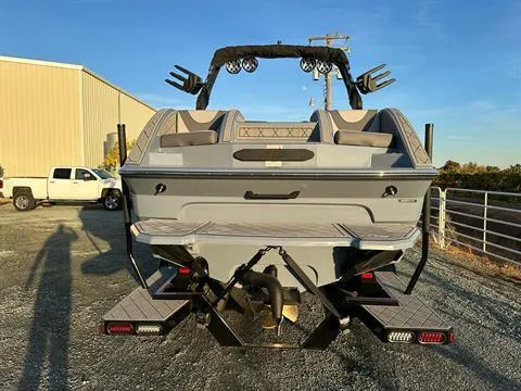 Slide: The Image of 2025 MB B52 25 Alpha boat, rear view, parked outdoors, showcasing sleek design and features. - 7