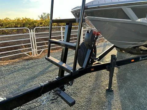 Slide: The Image of 2025 MB B52 25 Alpha boat trailer with ladder on gravel road. - 8