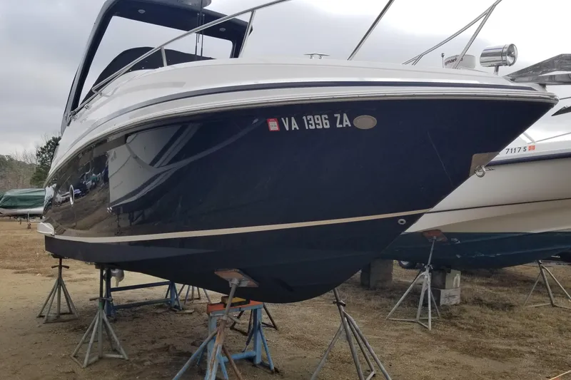 Slide: The Image of 2018 Regal 28 Express boat on stands, displayed outdoors. - 1