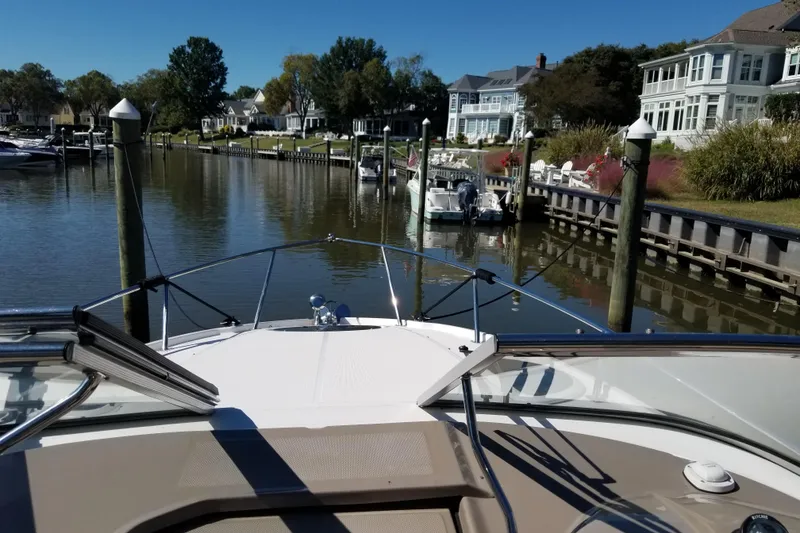 Slide: The Image of Bow view of 2018 Regal 28 Express docked in a scenic marina. - 6