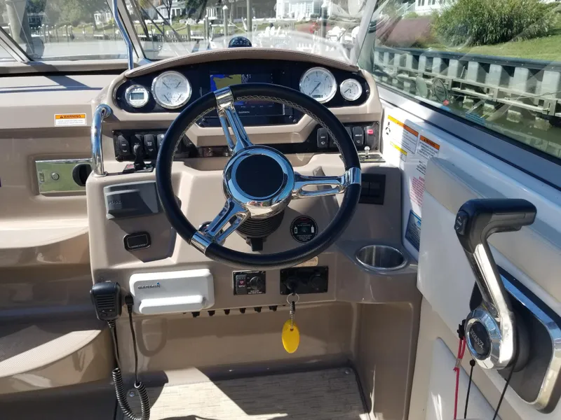 Slide: The Image of Cockpit of 2018 Regal 28 Express boat with steering wheel and control panel. - 8