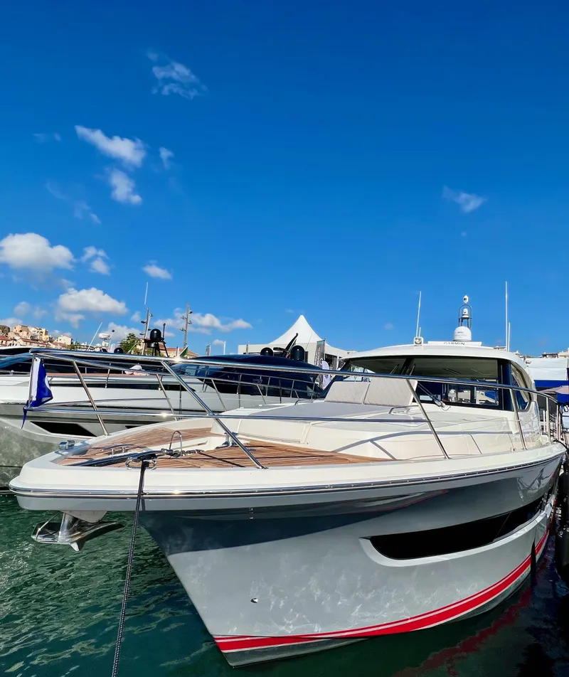 Slide: The Image of 2022 Riviera 505 SUV yacht docked under clear blue sky. - 10