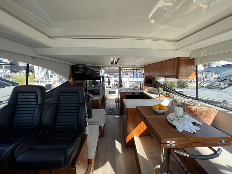 Slide: The Image of Luxurious interior of 2022 Riviera 505 SUV yacht with modern seating and dining area. - 26
