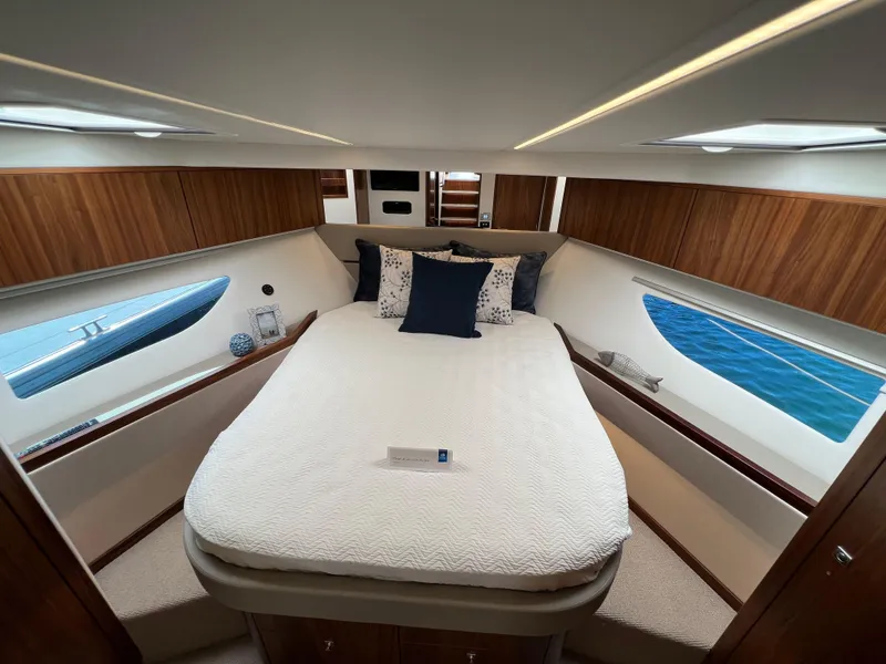 Slide: The Image of Luxurious bedroom interior of 2022 Riviera 505 SUV yacht with elegant wood paneling. - 34