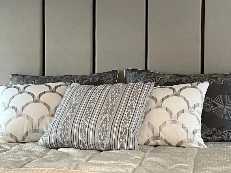 Slide: The Image of Luxurious bedding with patterned pillows in a 2022 Riviera 505 SUV interior. - 44