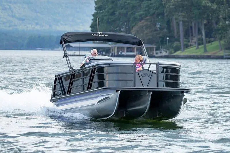 Slide: The Image of 2025 Veranda Vertex 22RC pontoon boat cruising on a scenic lake. - 4