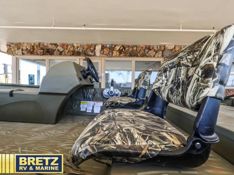 Slide: The Image of 2025 Grizzly 1754 SC boat interior with camo seats at Bretz RV & Marine showroom. - 10