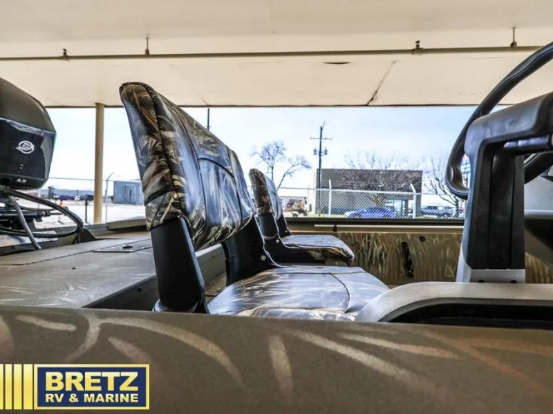 Slide: The Image of 2025 Grizzly 1754 SC boat interior with camo seats at Bretz RV & Marine. - 12