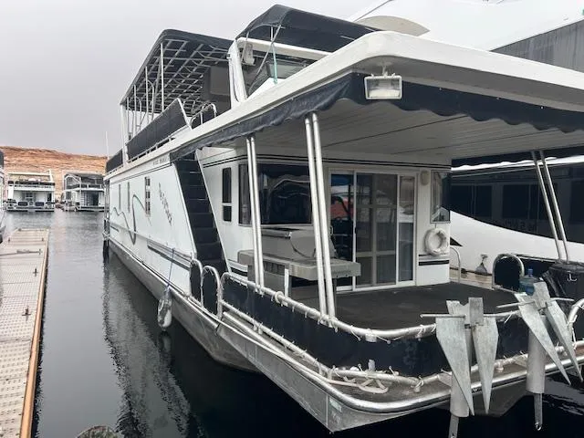 Slide: The Image of 2007 Lakeview Houseboat docked, featuring spacious deck and modern design. - 1