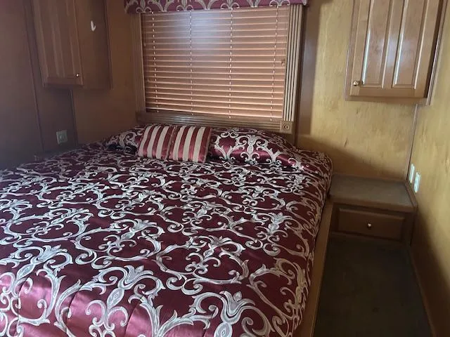Slide: The Image of 2007 Lakeview houseboat bedroom with ornate bedding and wooden cabinetry. - 11