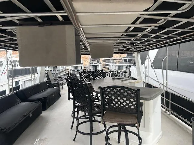 Slide: The Image of Spacious deck of 2007 Lakeview houseboat with seating and bar area. - 17