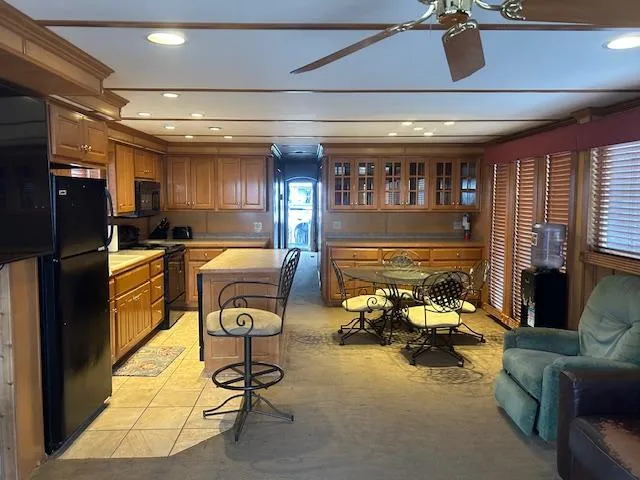 Slide: The Image of Interior of a 2007 Lakeview houseboat with kitchen and dining area. - 4