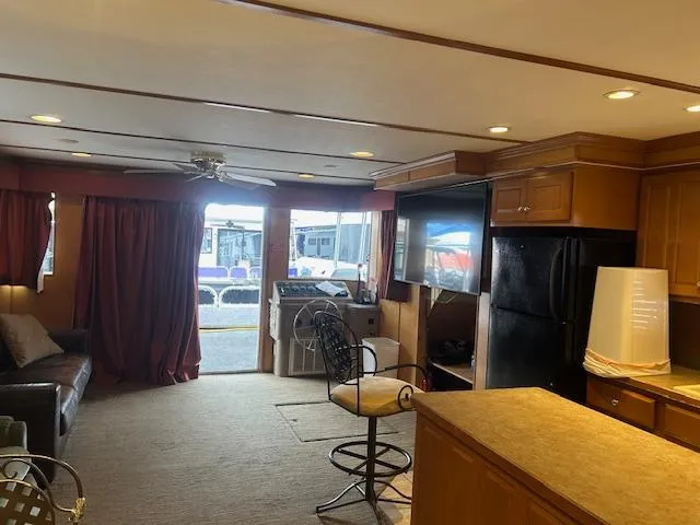 Slide: The Image of Interior of a 2007 Lakeview houseboat with kitchen and living area. - 5