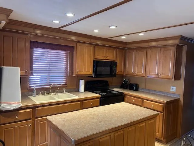 Slide: The Image of Spacious kitchen in 2007 Lakeview houseboat with wooden cabinets and modern appliances. - 6