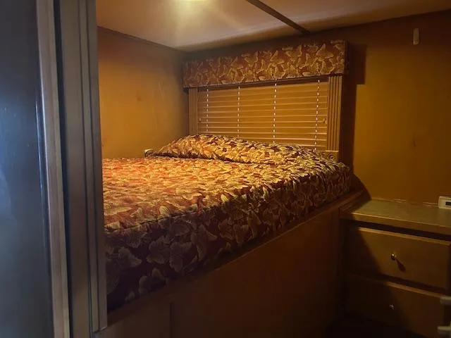 Slide: The Image of Cozy bedroom interior of 2007 Lakeview houseboat with floral bedding and wooden furnishings. - 7