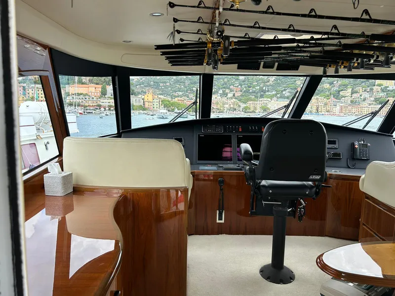 Slide: The Image of Interior of 2018 Viking 62 Enclosed Bridge yacht with helm and fishing rods. - 15