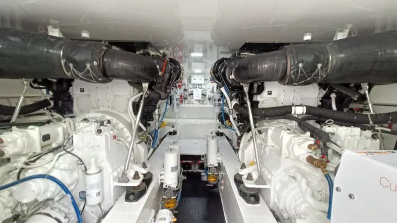 Slide: The Image of Engine room of 2018 Viking 62 Enclosed Bridge yacht, showcasing dual engines and mechanical systems. - 23