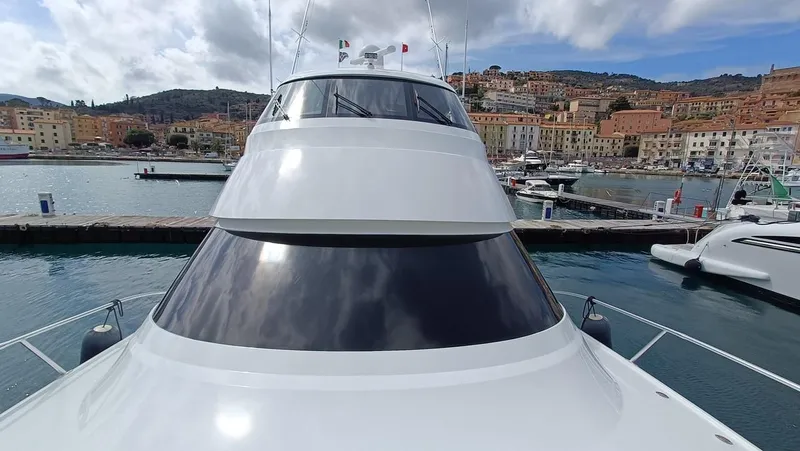 Slide: The Image of 2018 Viking 62 Enclosed Bridge yacht docked in a scenic harbor. - 38