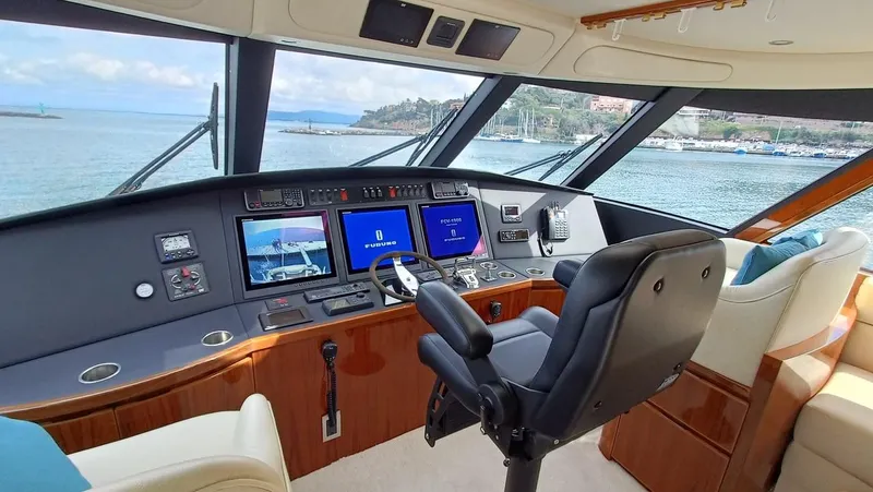 Slide: The Image of 2018 Viking 62 Enclosed Bridge yacht cockpit with navigation screens and leather seating. - 42